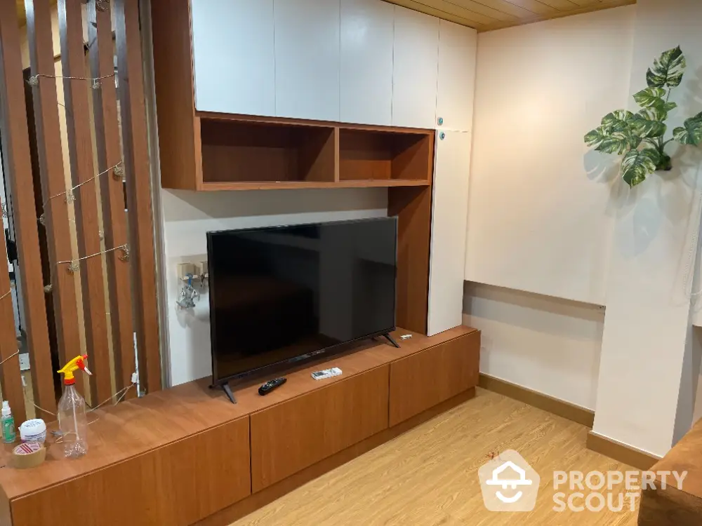 Modern living room with sleek wooden TV unit and contemporary decor