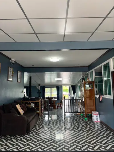 Spacious living room with modern tiled flooring and cozy seating area.
