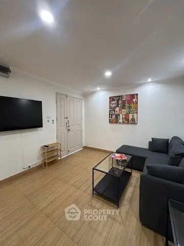 Modern living room with sleek furniture and wall art, perfect for relaxation.