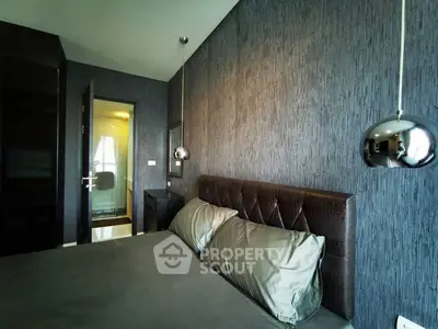 Modern bedroom with stylish decor and elegant lighting fixtures.