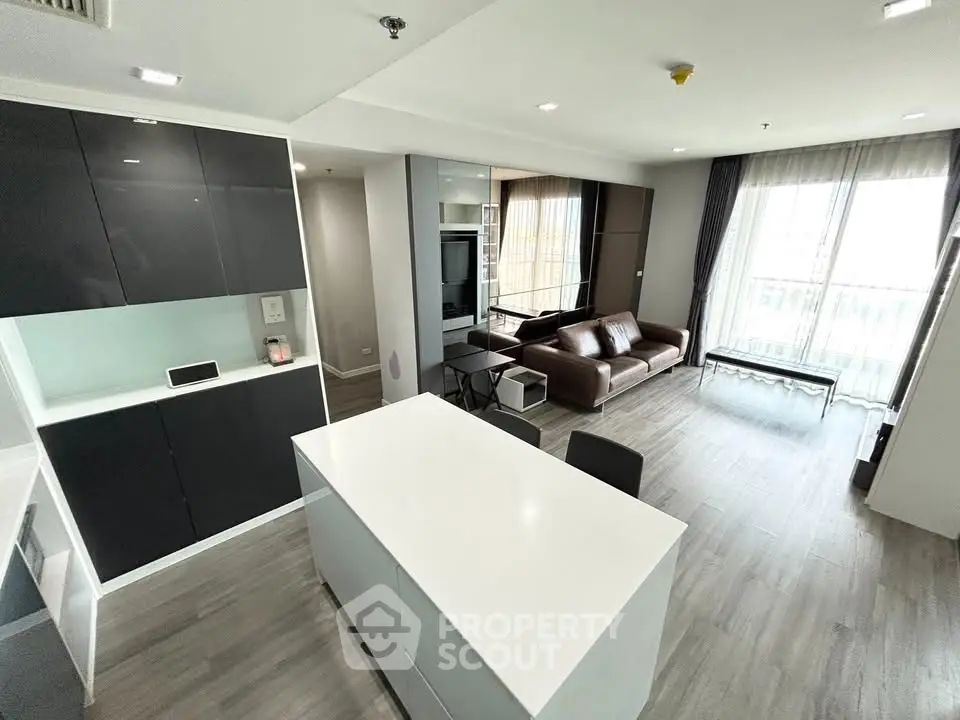 Modern open-plan living room with sleek kitchen and stylish furnishings