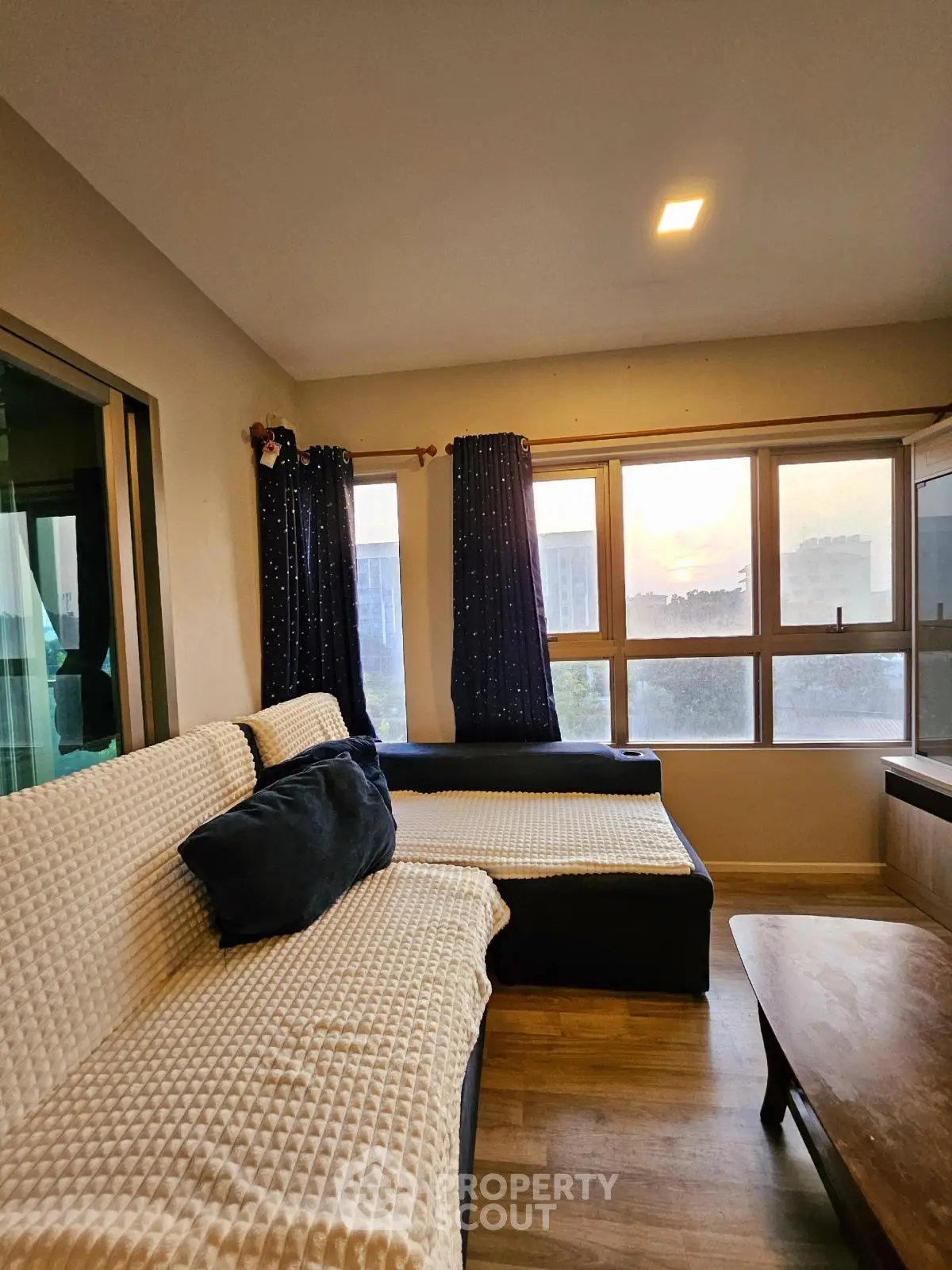 Cozy living room with large windows and comfortable seating