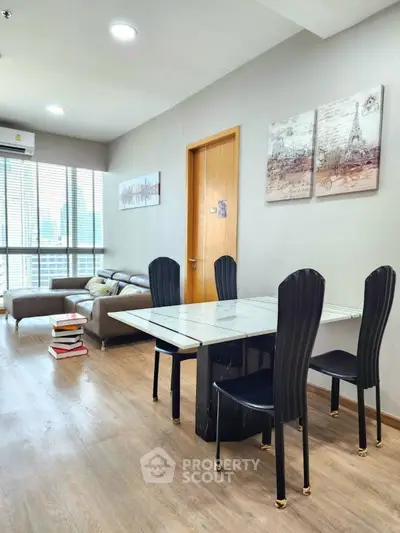 Modern living room with elegant dining area and city view