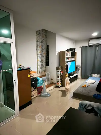 Modern living room with sleek furniture and large windows, perfect for cozy family gatherings.