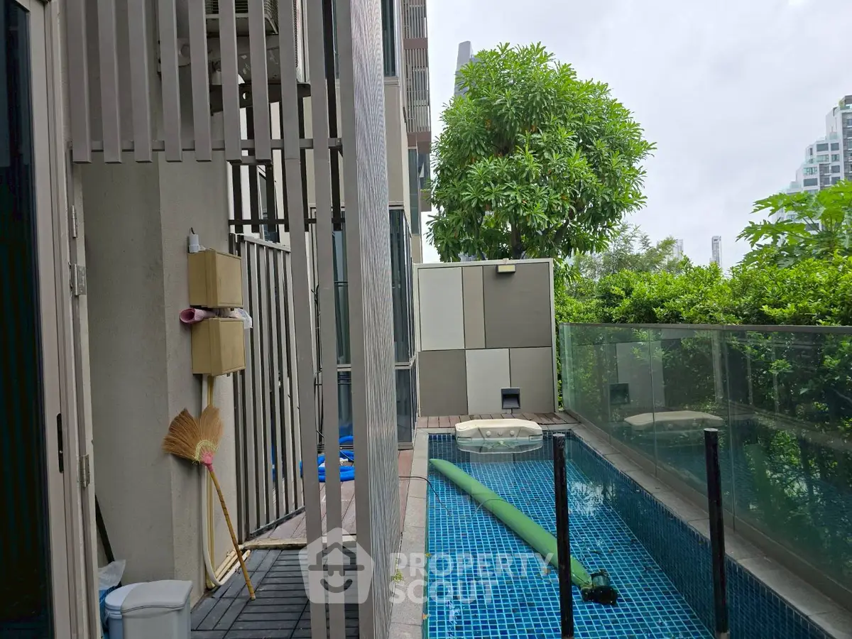 Charming urban poolside with lush greenery and modern design, perfect for relaxation and leisure.