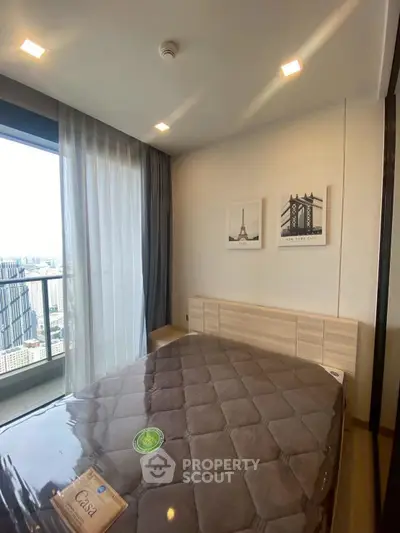 Modern bedroom with city view and stylish decor in high-rise apartment