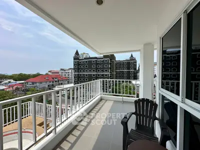 Spacious balcony with stunning city view and modern outdoor seating.