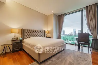 Luxurious bedroom with city view, elegant furnishings, and large windows in modern apartment.