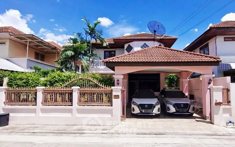 Charming suburban house with a tiled roof and double garage in a peaceful neighborhood.
