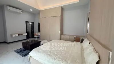 Spacious modern bedroom with elegant design and ample natural light