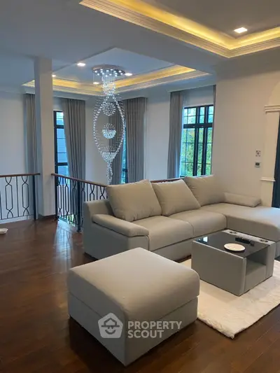 Luxurious living room with elegant chandelier and modern sofa in a stylish home