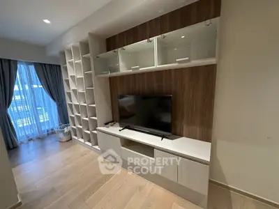 Modern living room with built-in TV unit and large window with curtains
