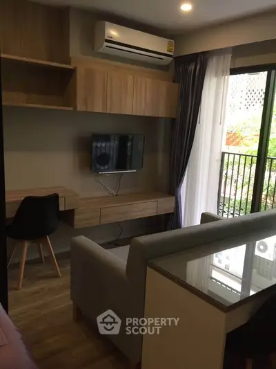 Modern living room with sleek furniture and balcony view in a stylish apartment.