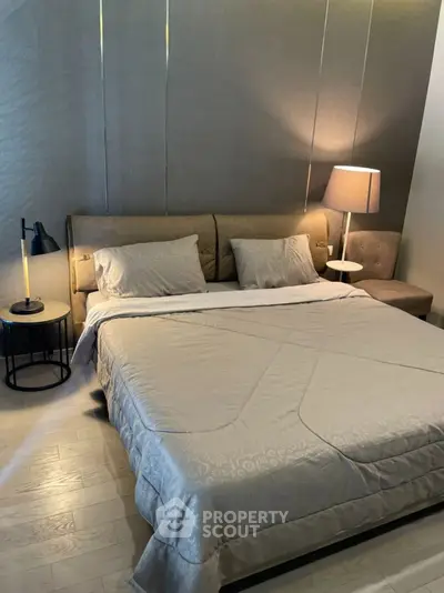 Cozy bedroom with modern decor and soft lighting, perfect for relaxation.
