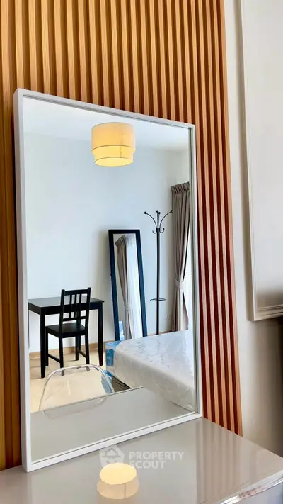 Modern bedroom with stylish mirror and wooden paneling