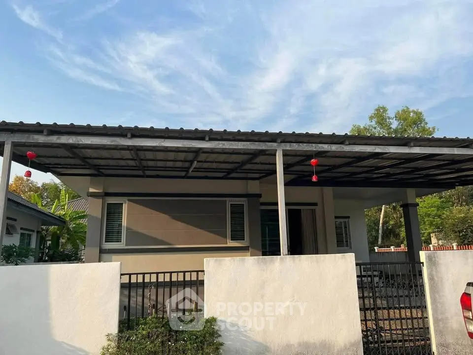 Charming single-story home with modern exterior and spacious front yard, perfect for family living.