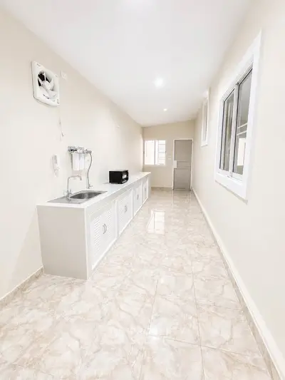 Spacious kitchen with sleek countertops and modern appliances in a bright, airy setting.