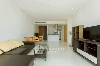 Spacious modern living room with open kitchen and sleek furnishings