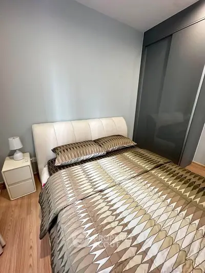 Cozy bedroom with modern decor and stylish bedding in a contemporary apartment.