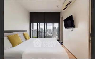 Modern bedroom with city view, featuring sleek design and large windows for natural light.