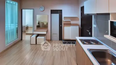 Modern studio apartment with open kitchen and stylish wooden flooring