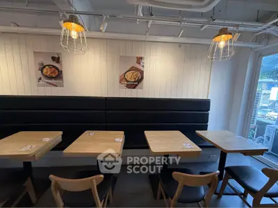 Chic cafe interior with modern wooden tables and stylish lighting