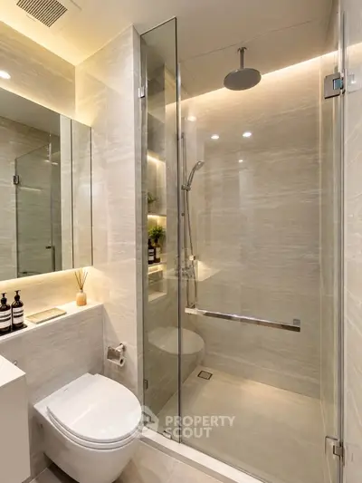 Luxurious modern bathroom with glass shower and elegant lighting