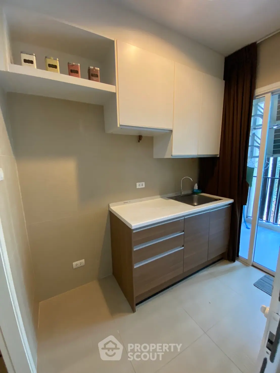 Modern kitchen with sleek cabinetry and balcony access