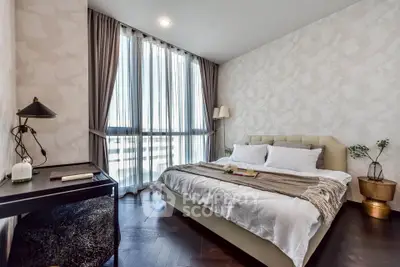 Elegant bedroom with large window and stylish decor