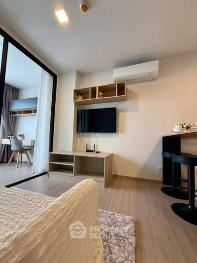 Modern living room with sleek design, featuring a wall-mounted TV and air conditioning, perfect for urban living.