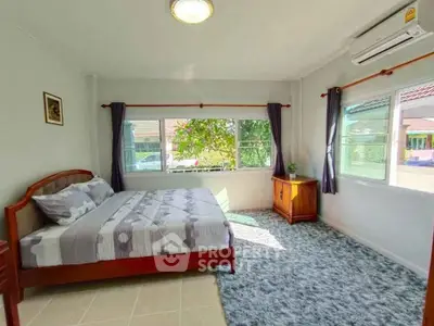 Bright and cozy bedroom with large windows and modern decor