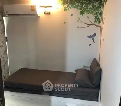 Cozy bedroom with wall art and built-in storage bed, perfect for compact living spaces.