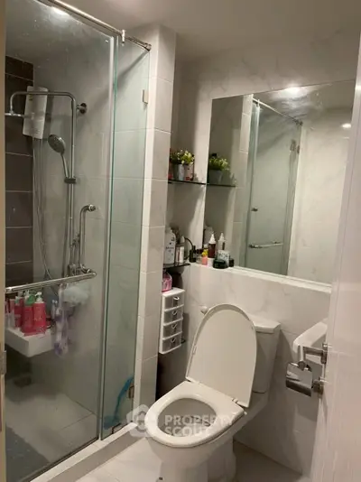 Modern bathroom with glass shower and sleek fixtures in a contemporary home.