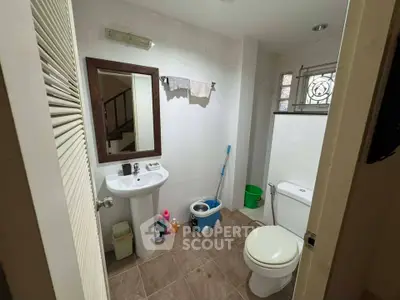 Cozy bathroom with modern fixtures and tiled flooring, ideal for comfort and style.