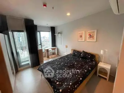 Modern bedroom with city view, stylish decor, and balcony access in urban apartment.