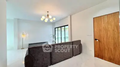 Spacious modern living room with elegant lighting and large windows for natural light.