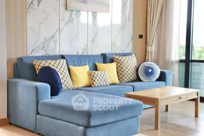 Stylish living room with blue sectional sofa and elegant decor