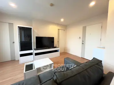 Modern living room with sleek furniture and large TV, perfect for relaxation.