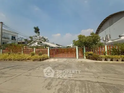 Spacious industrial property with secure gated entrance and ample outdoor space.