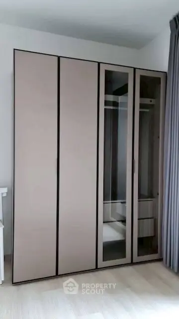 Modern bedroom with sleek wardrobe and neutral tones