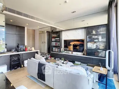 Modern living room with sleek design, large windows, and built-in shelving in a high-rise apartment.
