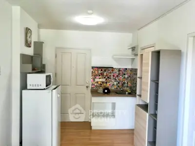 Charming compact kitchen with colorful backsplash and modern appliances