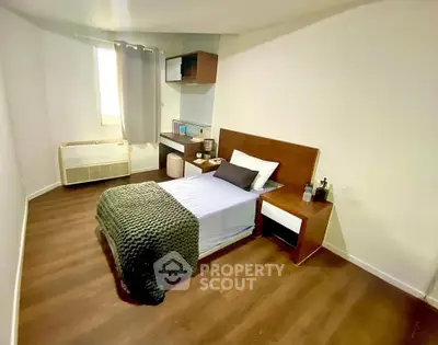 Cozy bedroom with modern furnishings and wooden flooring