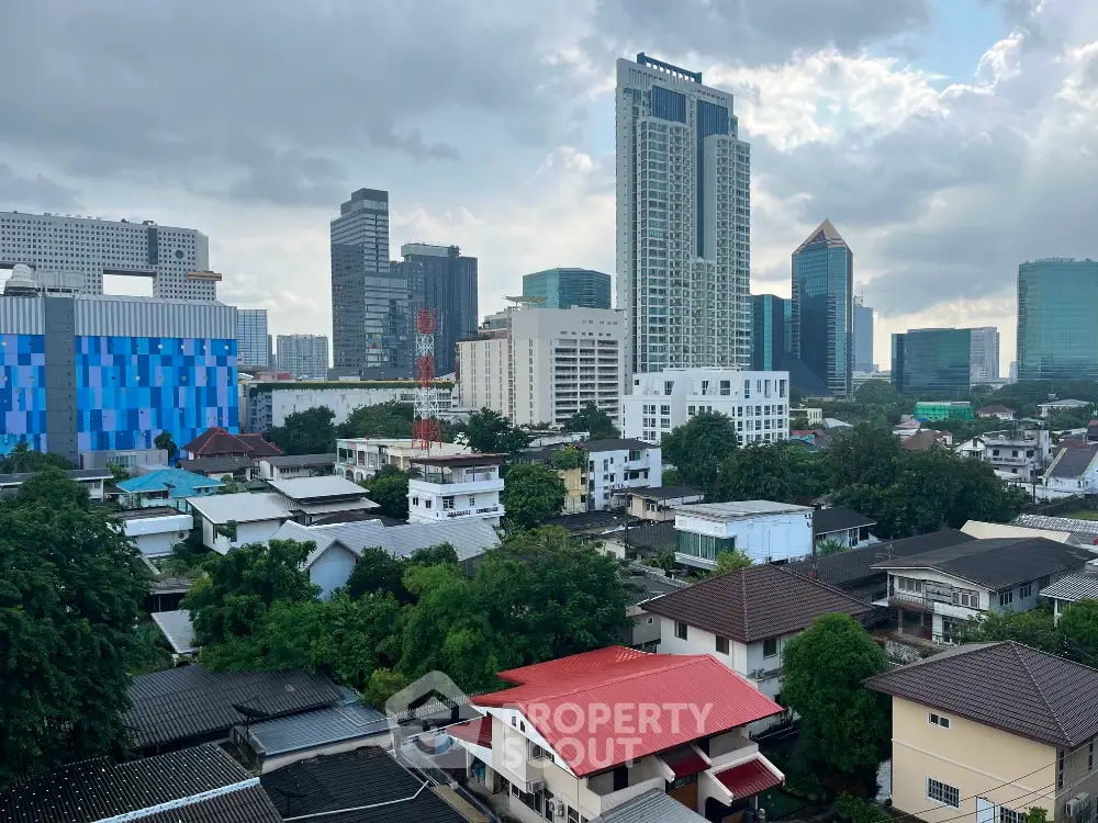 Stunning cityscape view showcasing modern skyscrapers and residential buildings under a cloudy sky.