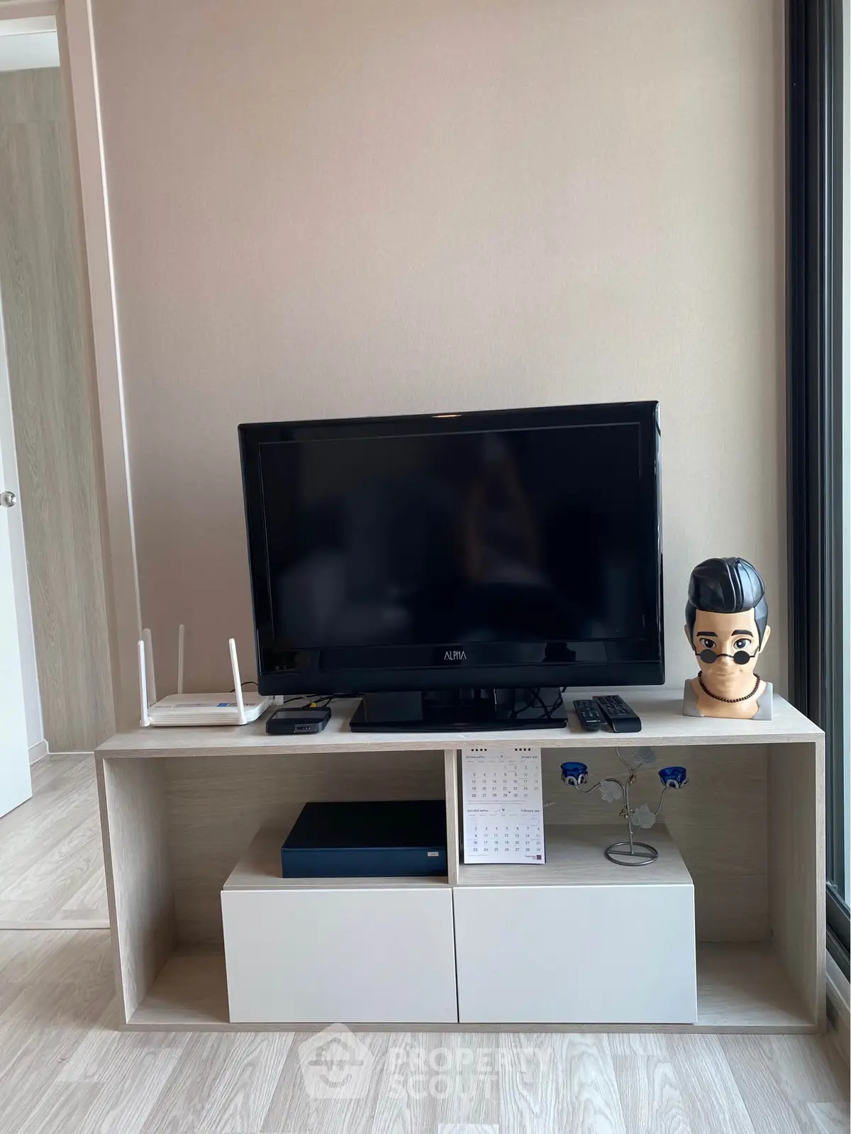 Modern living room setup with TV and stylish decor in a cozy apartment.