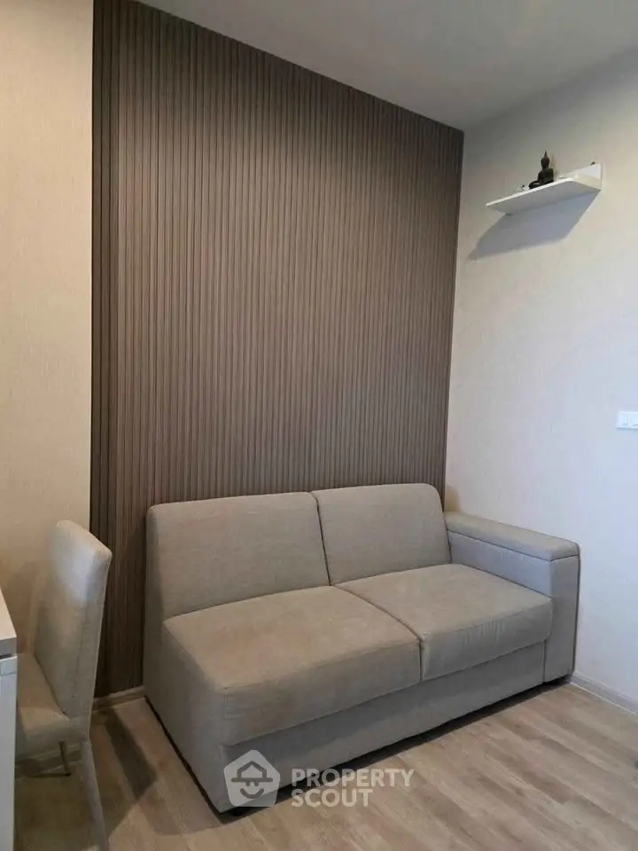 Modern living room with stylish sofa and elegant wall paneling