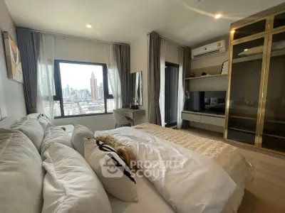 Luxurious bedroom with city view, modern decor, and ample natural light in high-rise apartment.