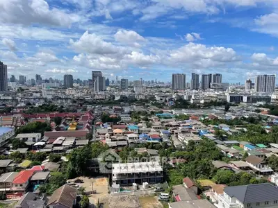 Stunning cityscape view showcasing urban skyline and residential areas under a vibrant blue sky.
