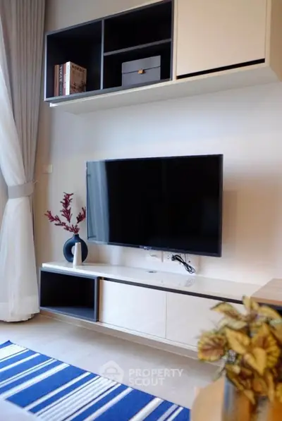 Modern living room with sleek TV setup and stylish shelving