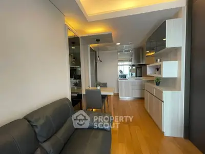 Modern living room with open kitchen and stylish decor in a cozy apartment.
